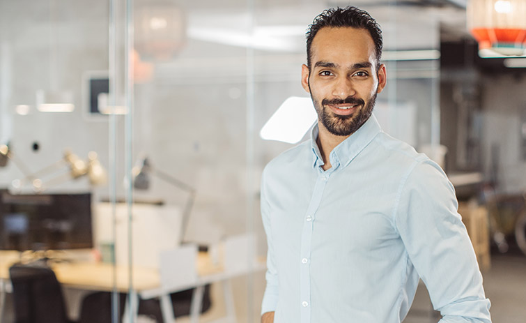 Man in office looking at camera