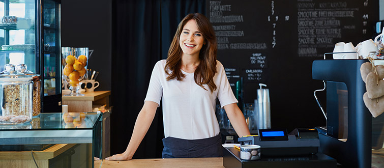 Woman working behind counter in cafe